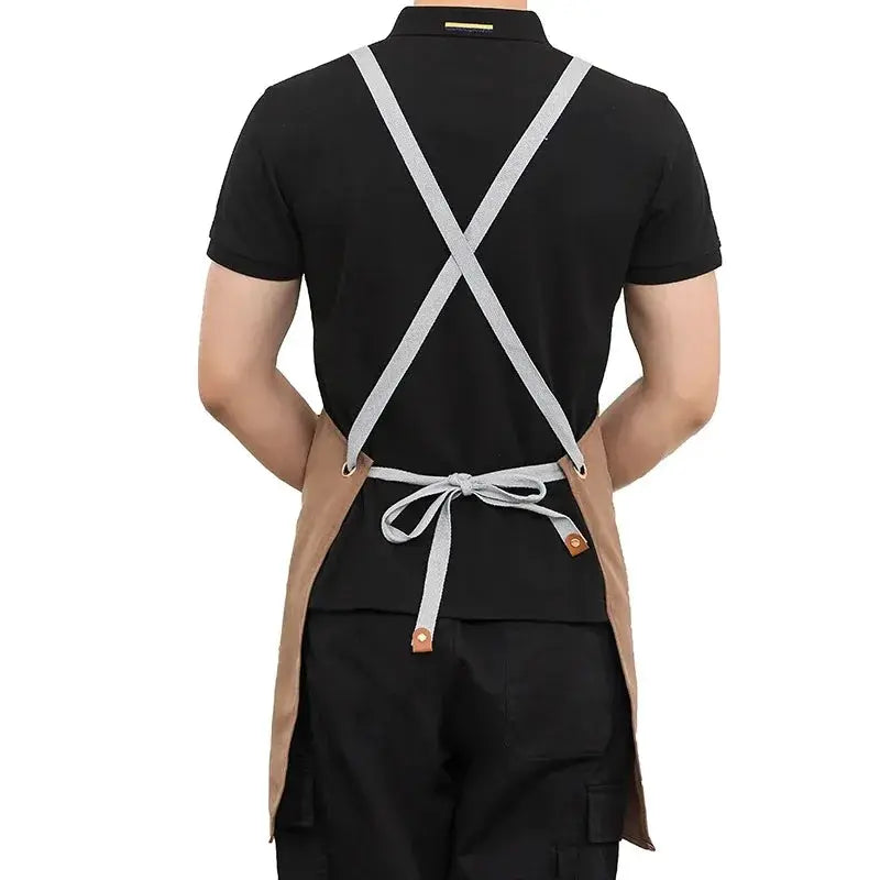 Waterproof kitchen apron with cross-back gray straps and tied waist, brown side panels