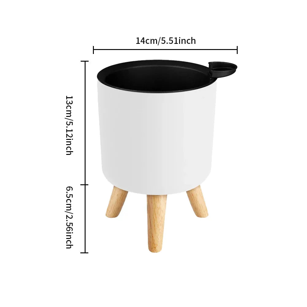 Floor-standing round planter with wooden legs, white pot and black interior rim, self-watering drainage system