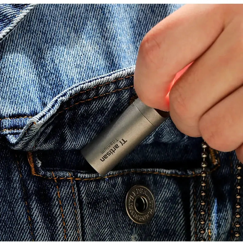 Tiartisan titanium mini EDC pill bottle; waterproof, pocket-sized pill container in denim jeans pocket