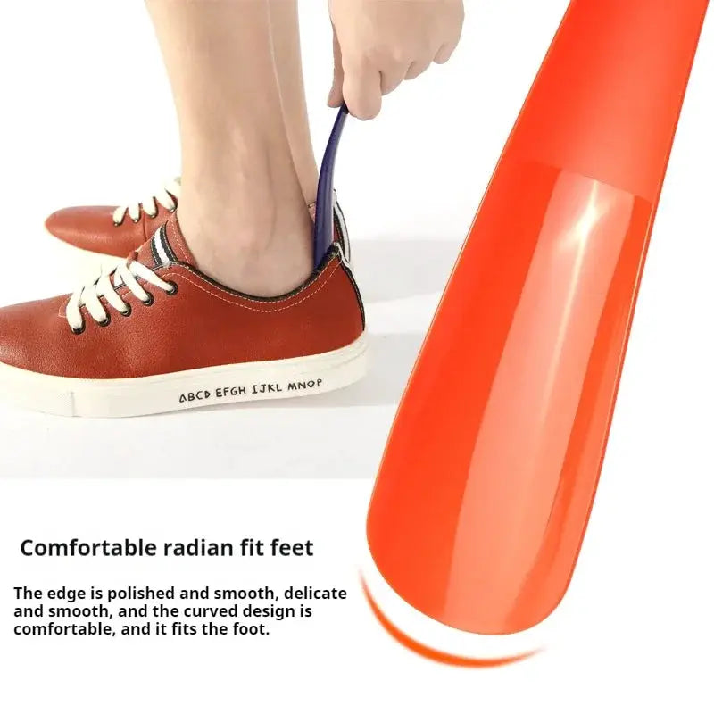 Orange plastic shoe horn with short 16 cm handle for easy home use