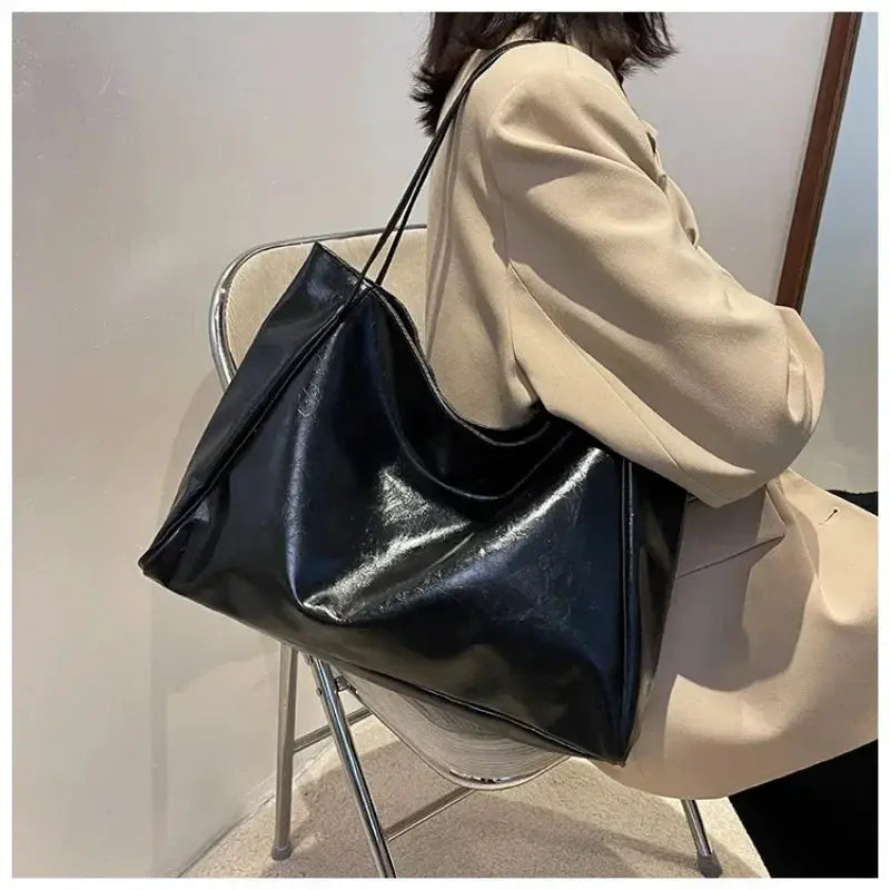 Women tote bag in black soft PU leather with large capacity, shoulder bag for casual wear.