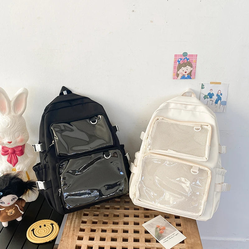 Two Japanese Style Transparent Ita Bag backpacks by Simples Market, black and cream with clear mesh pockets.