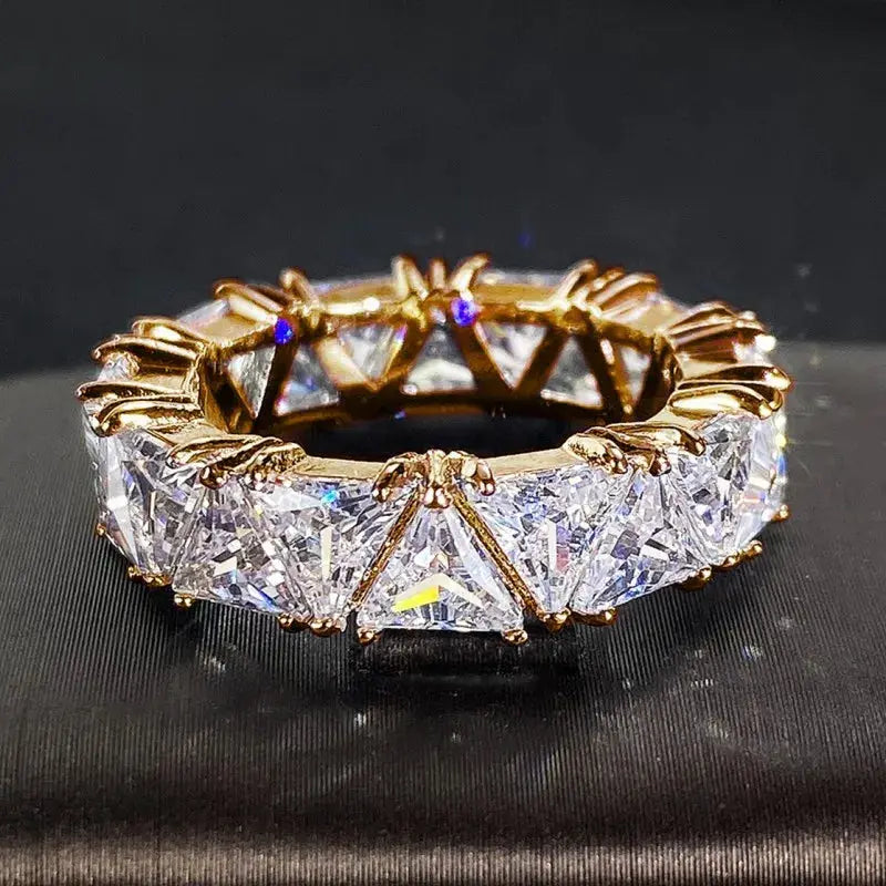 Ring: gold-tone brass promise ring with triangle-cut cubic zirconia stones.