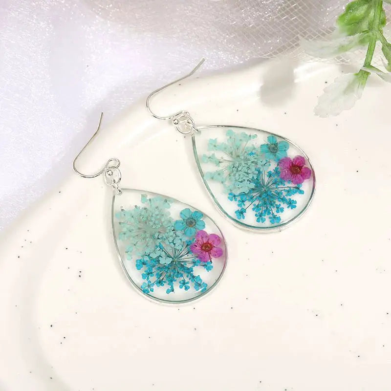 Teardrop resin earrings, pair with blue and pink pressed flowers in clear epoxy