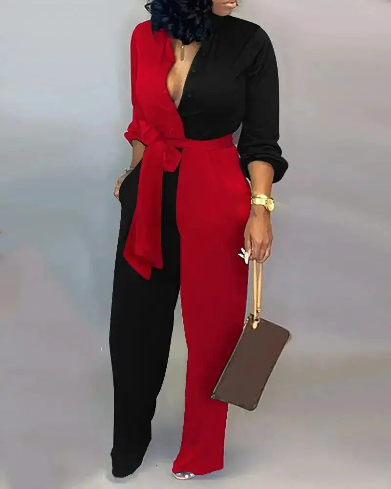 Women's color-block long-sleeve jumpsuit with red and black panels and waist belt, brown handbag