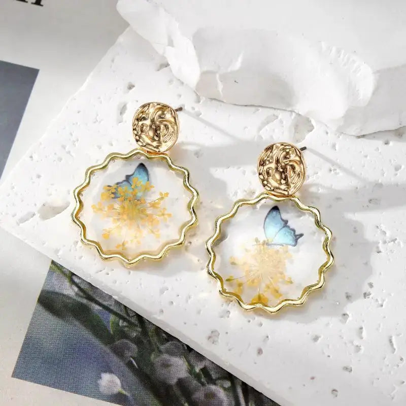Natural flower dangle earrings, Simples Market, gold scalloped resin hoops with pressed yellow flowers, pair.
