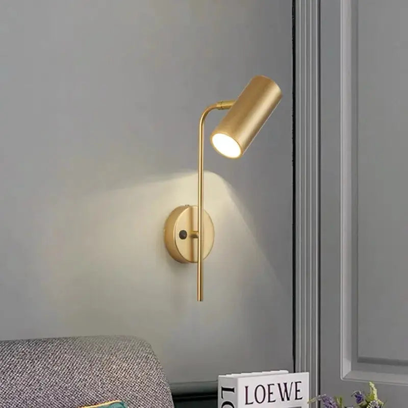 Brass-tone rotatable wall lamp with cylindrical plastic shade, modern bedroom sconce