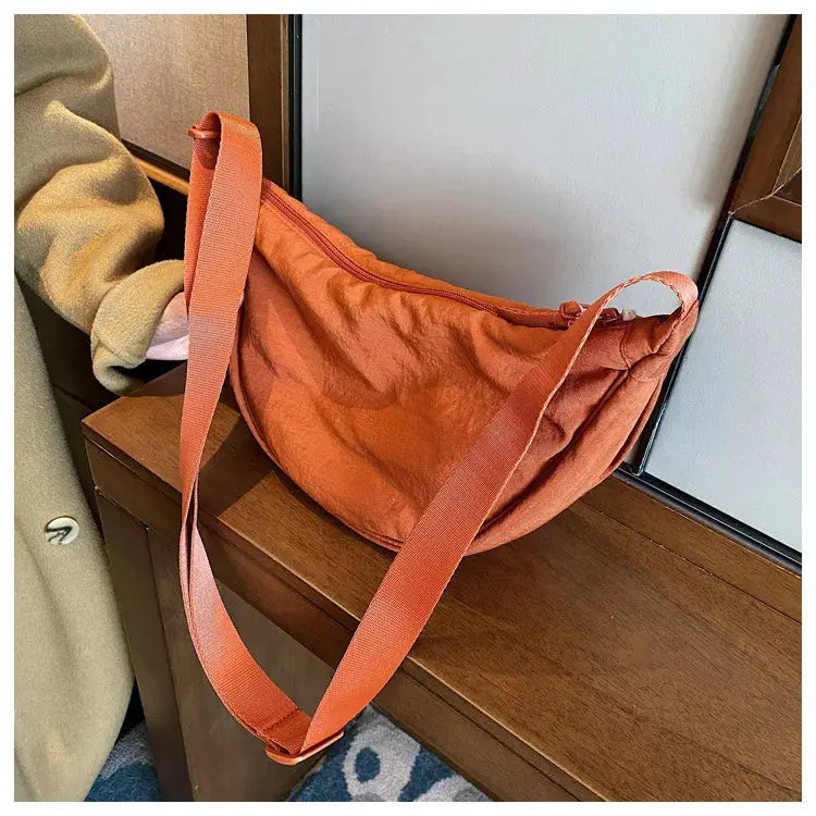 Casual nylon hobo crossbody bag for women in orange with adjustable strap
