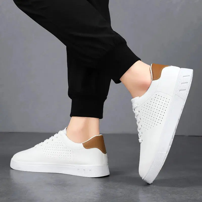 Men's white leather lace-up sneakers with perforated sides and brown heel patch.