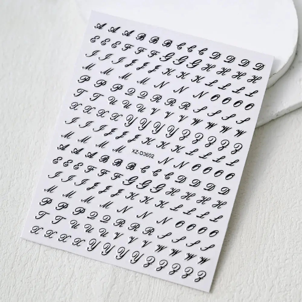 Nail sticker sheet featuring black 3D Roman alphabet letters, self-adhesive decals for manicures