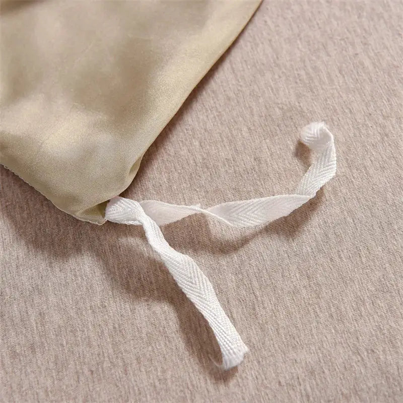 Satin duvet cover set in beige with white drawstring ties; 3-piece queen size