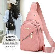 Pink quilted crossbody bag with front zipper pocket and gold hardware, adjustable strap