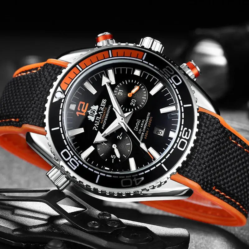 Paulareis P automatic men's watch with black dial, orange accents, stainless steel case and orange-trim fabric strap.
