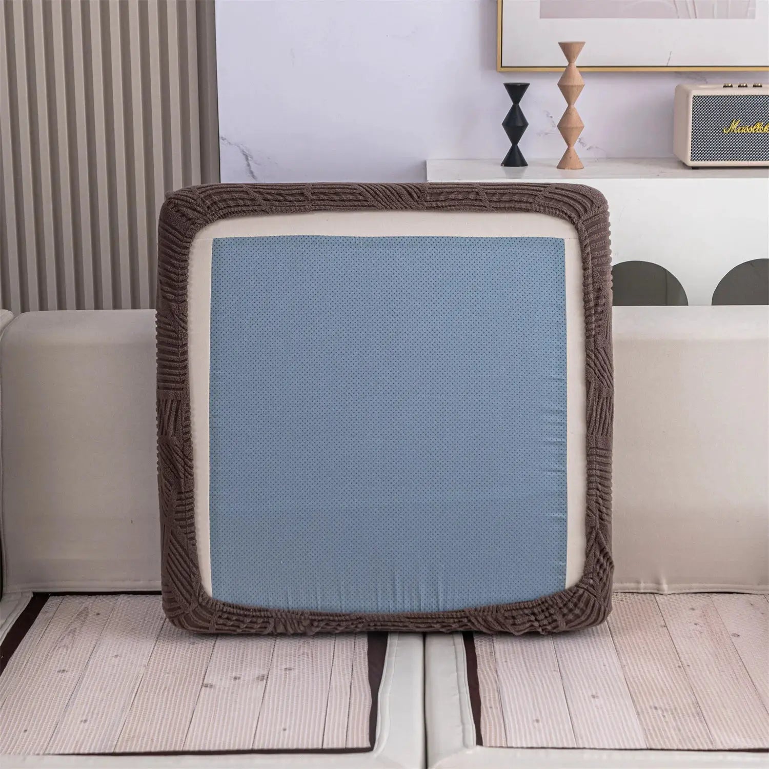 Sofa cover with brown jacquard border and blue perforated center panel, pet-friendly living room decor