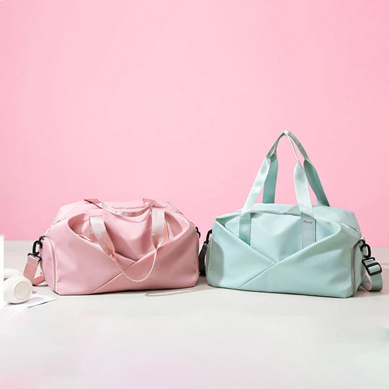 Two fitness gym bags in pink and mint with dual handles and shoulder straps