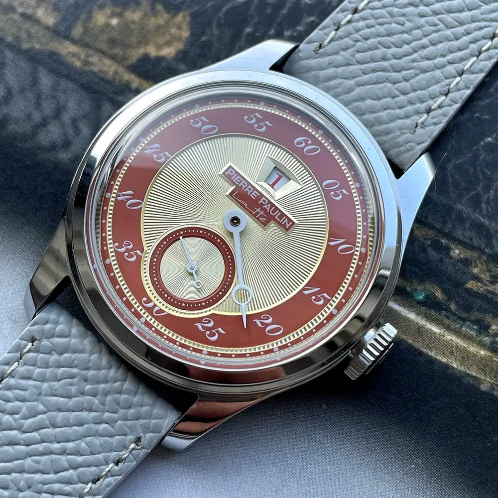 Pierre Paulin men's watch with salmon dial, gold center, red outer ring, date window, stainless steel case, gray strap