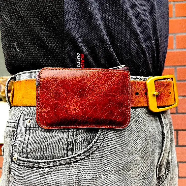 Mini zipper waist bag in brown leather with a tan belt and yellow buckle
