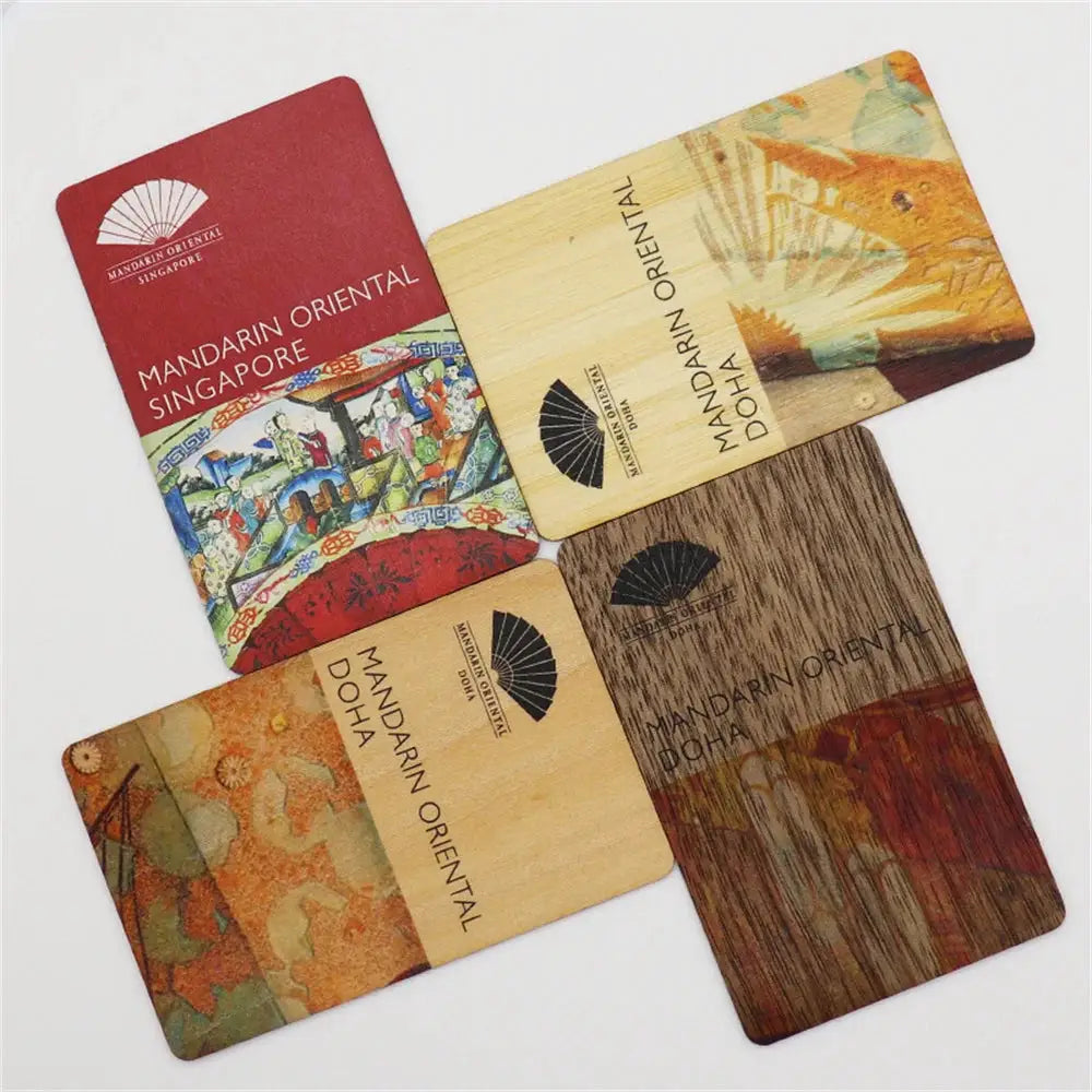 Five wooden cards branded Mandarin Oriental Singapore/Doha with varied designs.