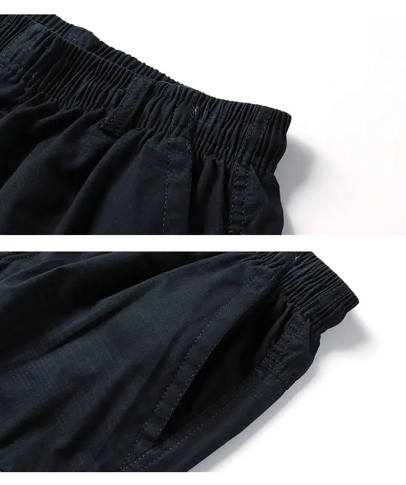 Men's knee-length casual shorts in dark navy cotton with elastic waistband and side pockets.