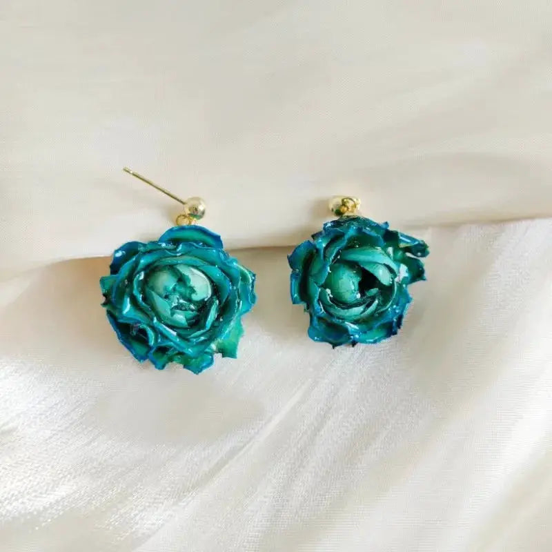 Turquoise blue epoxy resin rose earrings with gold-tone posts; pair featuring real rose petals