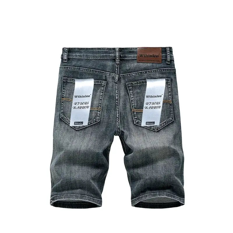 Men's denim shorts in dark blue with back pockets and ribbon tags; Whinlee label, Simples Market