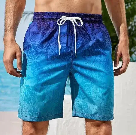 Board shorts for men; blue gradient quick-dry trunks with leaf pattern.