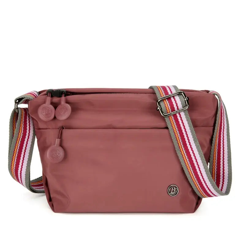 Nylon crossbody bag for women in pink with adjustable striped strap, zipper closure and front pocket