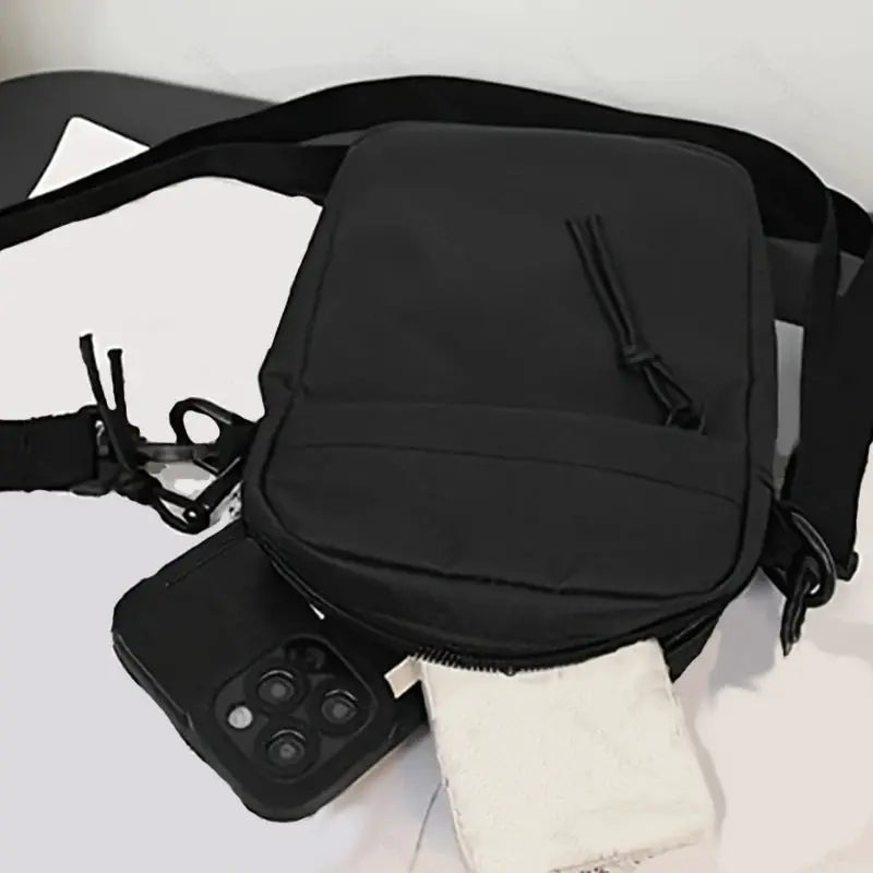 Simples Market black single-shoulder crossbody bag; compact, lightweight, shown with phone (2 items)