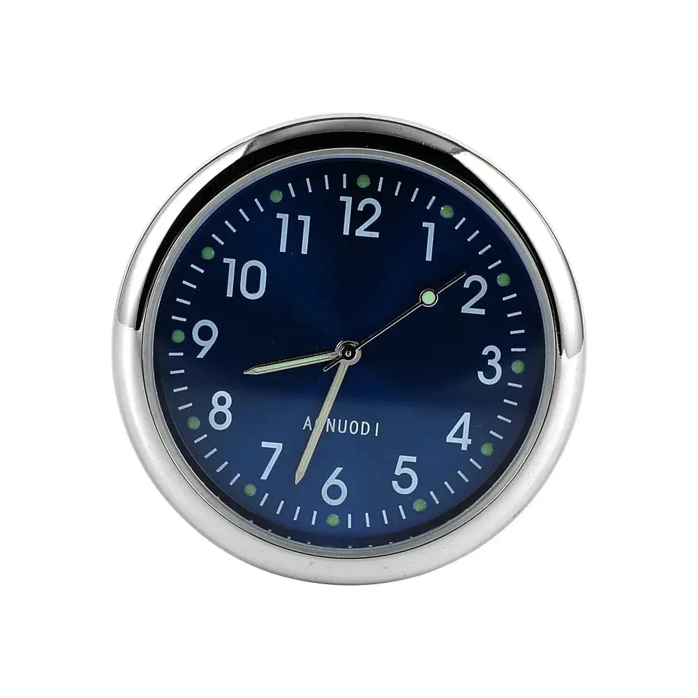 Car clock with blue dial, green luminous markers, and silver bezel