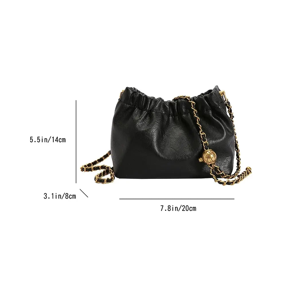 Women's black faux-leather bag with gold chain strap, drawstring top, crossbody/shoulder style.