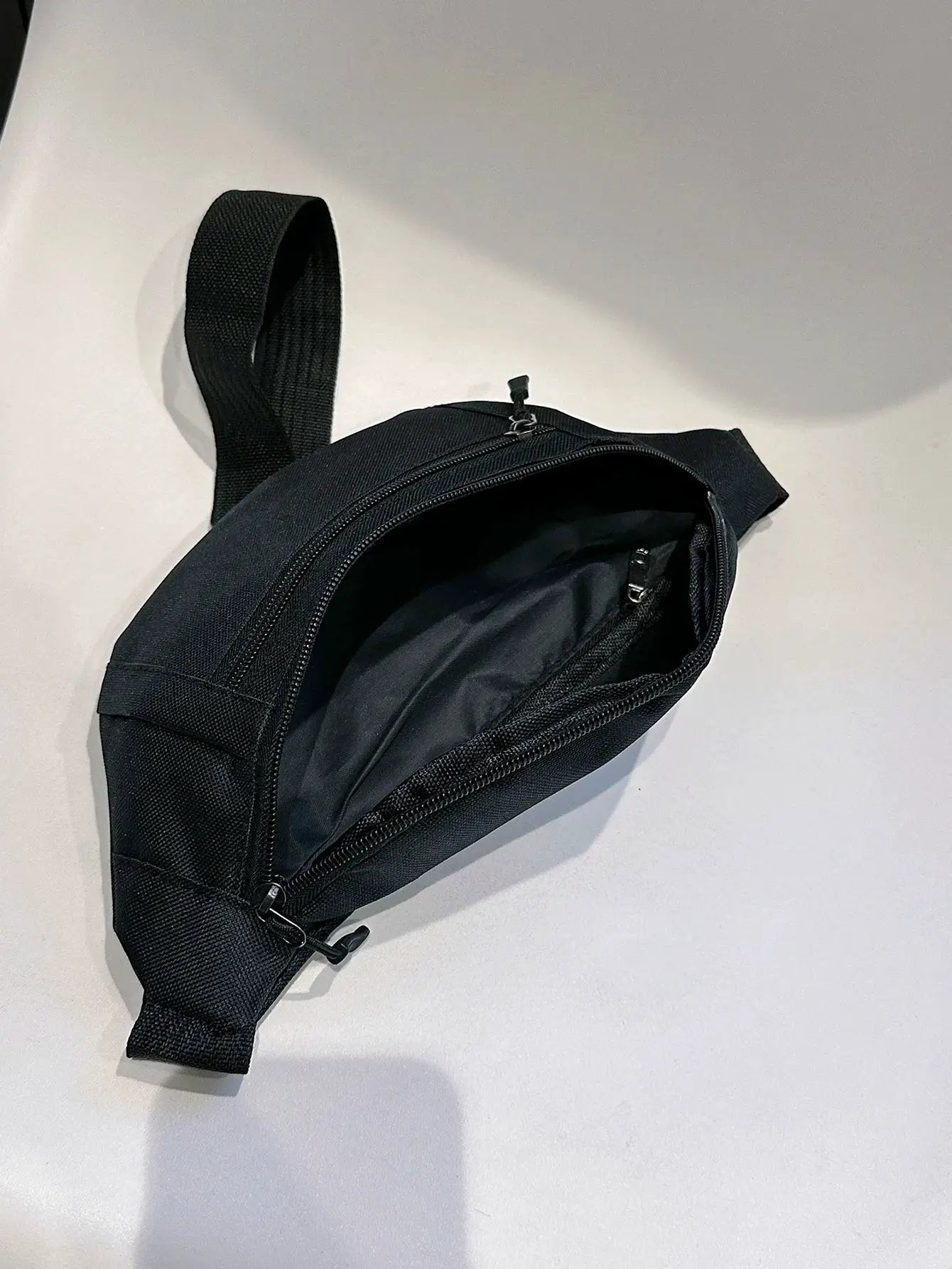 Fanny pack black with multiple zip compartments and an adjustable strap