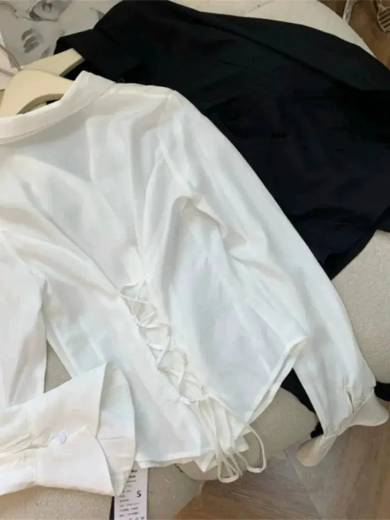 White lace-up-back blouse by Simples Market; black top also shown (2 pieces)