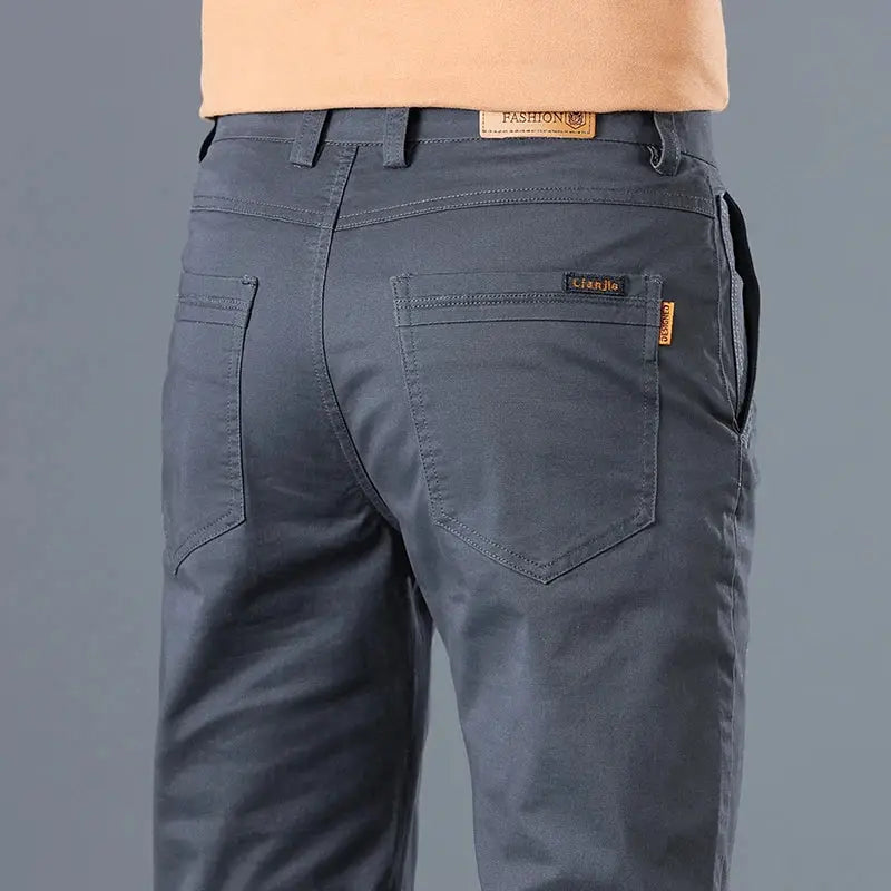 Simples Market men's cotton slim-straight pants in blue-gray, back view with two back pockets and brand tag.