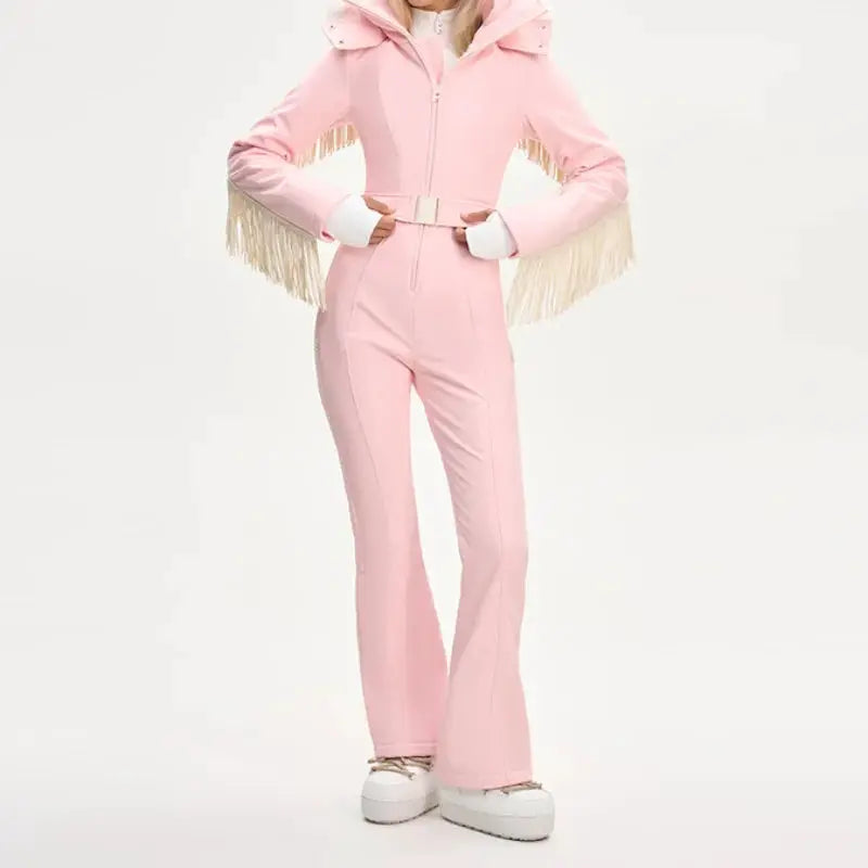 One-piece ski suit in pink with faux fur hood, fringe tassels and belt by Simples Market