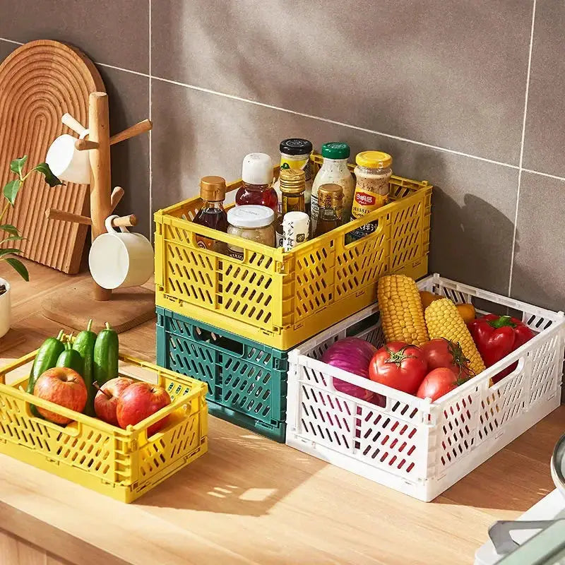 Simples Market 4 plastic foldable storage crates in yellow, green and white, stackable baskets filled with groceries.