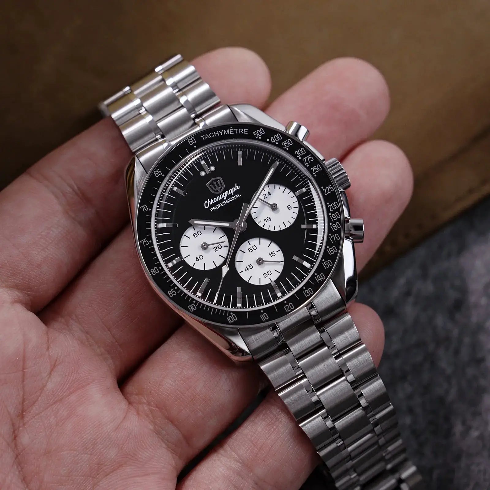 Men's stainless steel chronograph watch with black dial, white subdials, and tachymeter bezel.