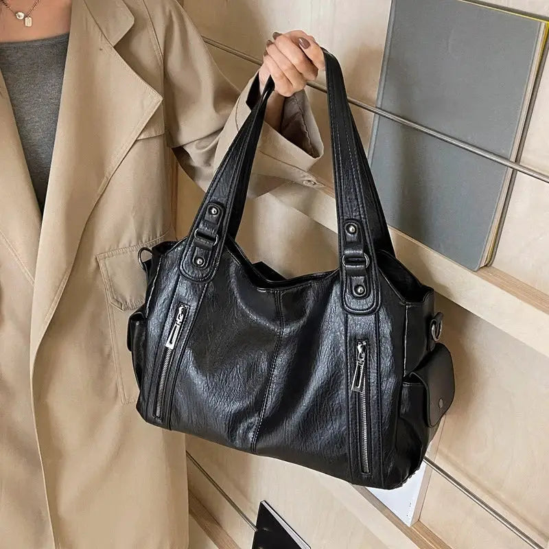 Black PU leather shoulder bag with dual top handles and front zip pockets.