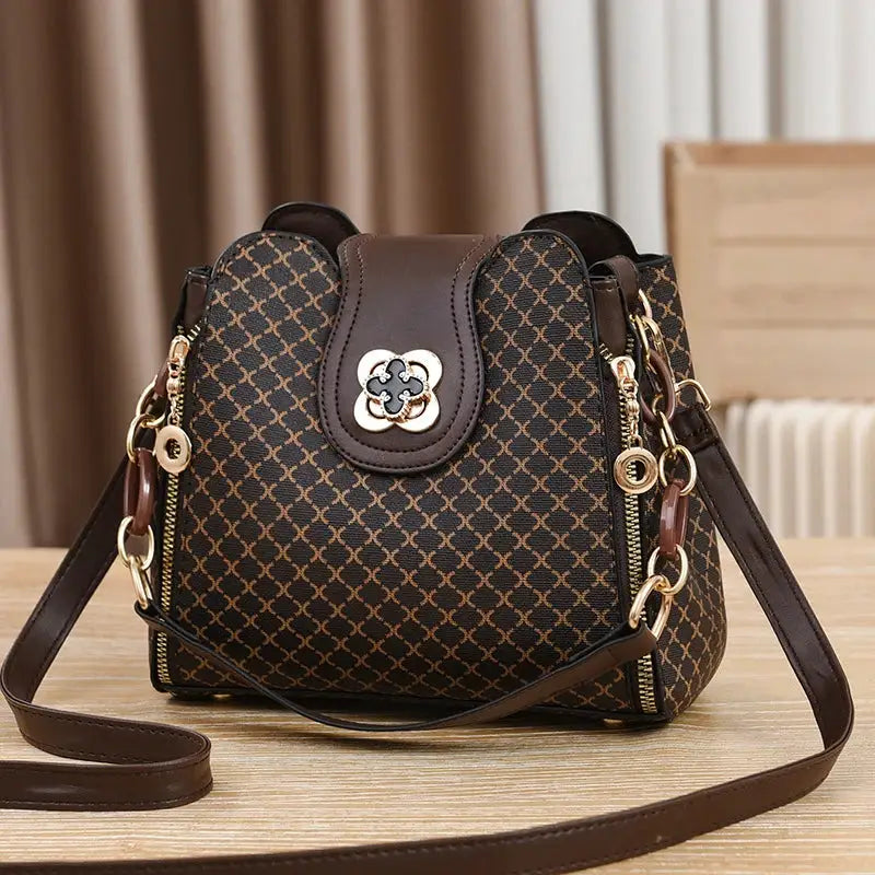 Simples Market women's crossbody handbag in dark brown check print with gold-tone hardware and leather trim
