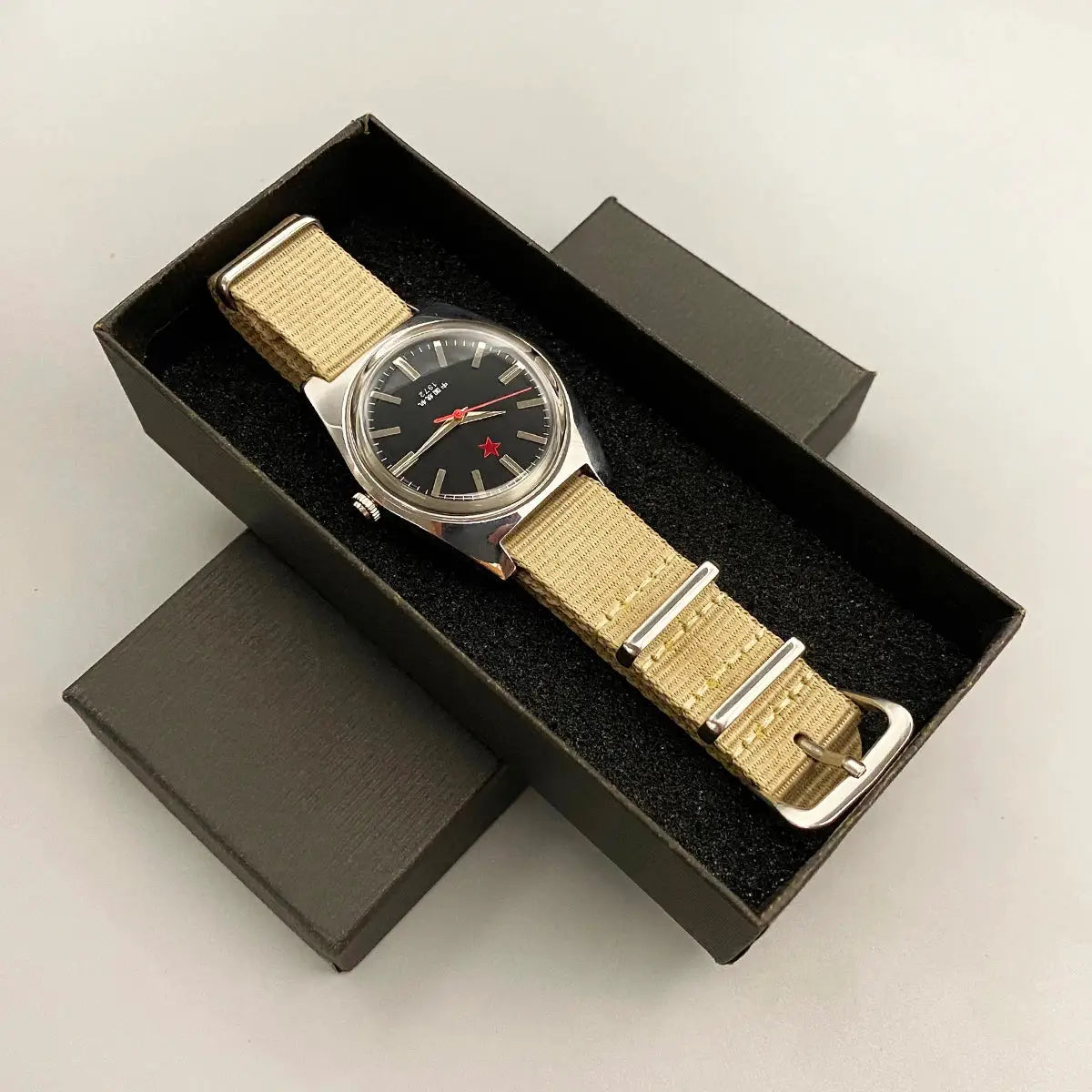 Men's mechanical watch, 36mm stainless steel case, black dial with red star, beige nylon strap.