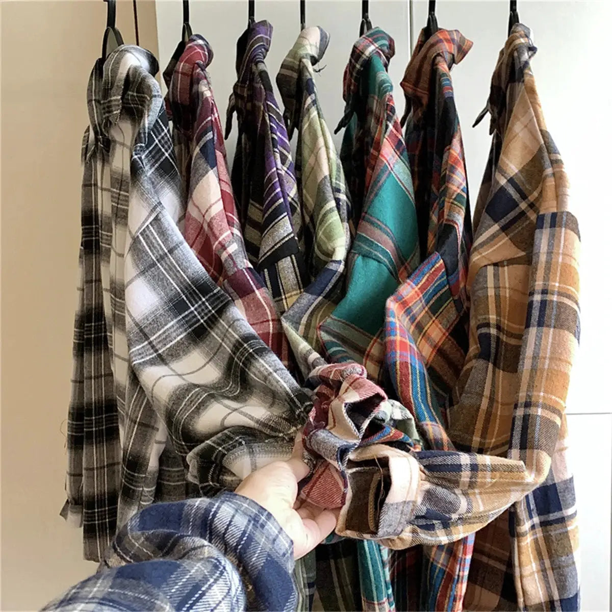 Simples Market Korean plaid blouses for women; multiple long-sleeve check shirts in multicolor plaids on hangers.