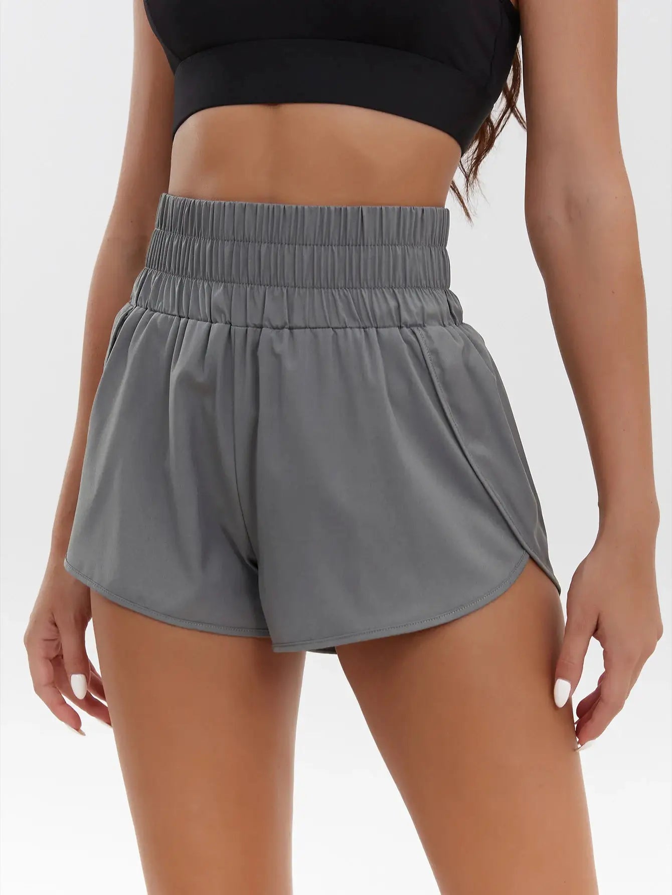 Women's gray high-waisted elastic sports shorts with ruched waistband.