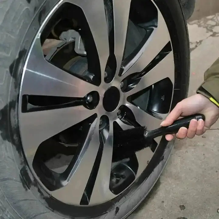 Car wheel cleaning brush, black handheld detailing tool for cleaning wheels and rims wet or dry.