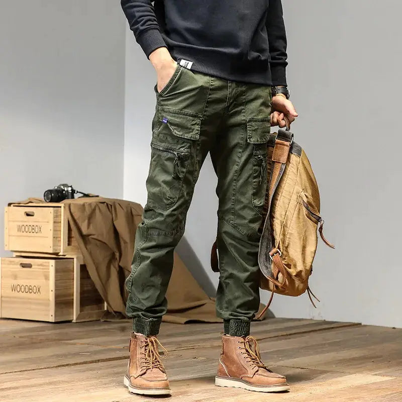 CAAYU men's cargo joggers in olive green with multiple pockets, zippers, and elastic cuffs