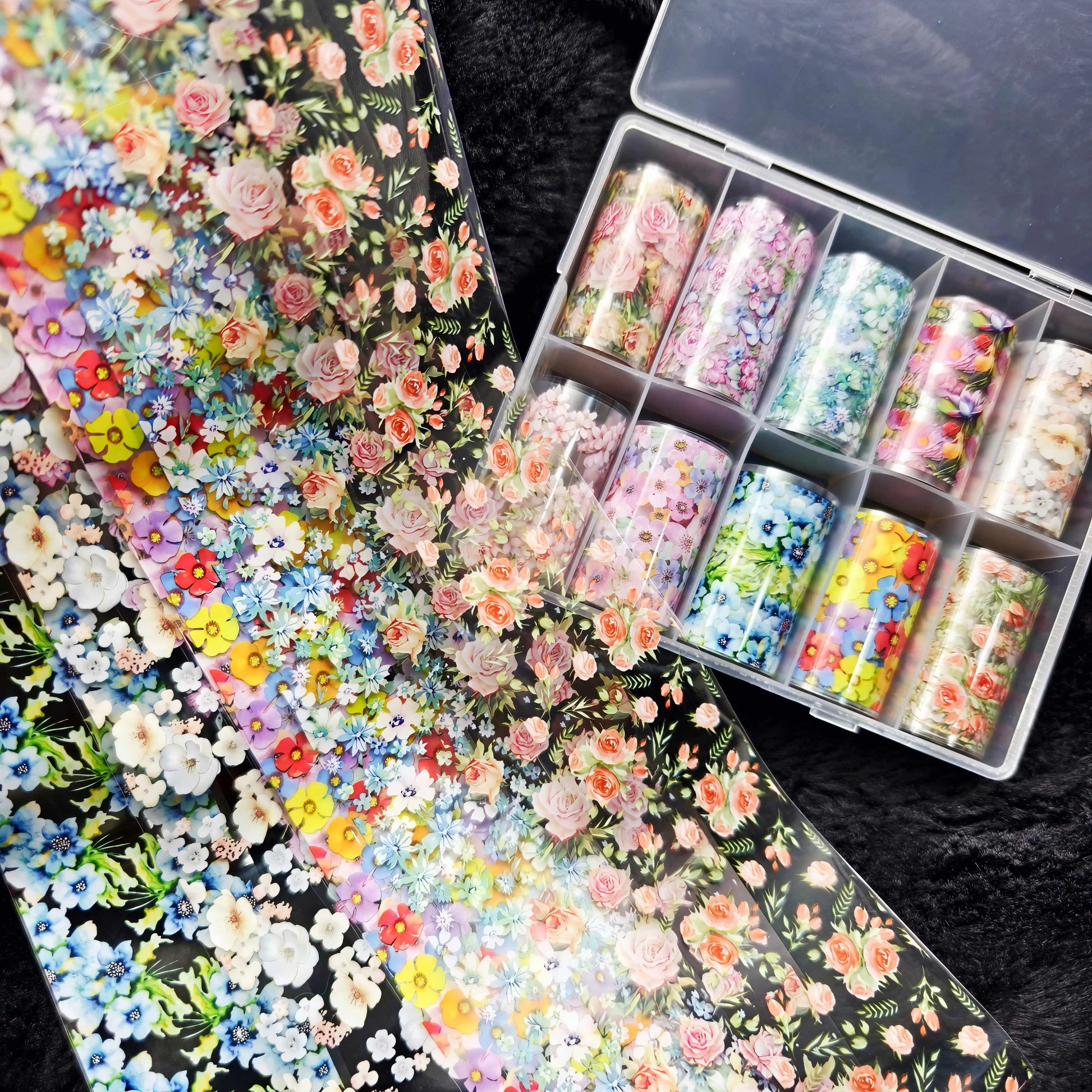 Nail foil decals: 10 rolls of colorful floral patterns in plastic cases for nail art.