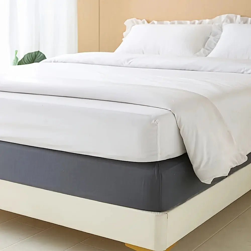 Stretchable white bed skirt with non-slip design; ultra-soft, machine-washable bed cover replacement.