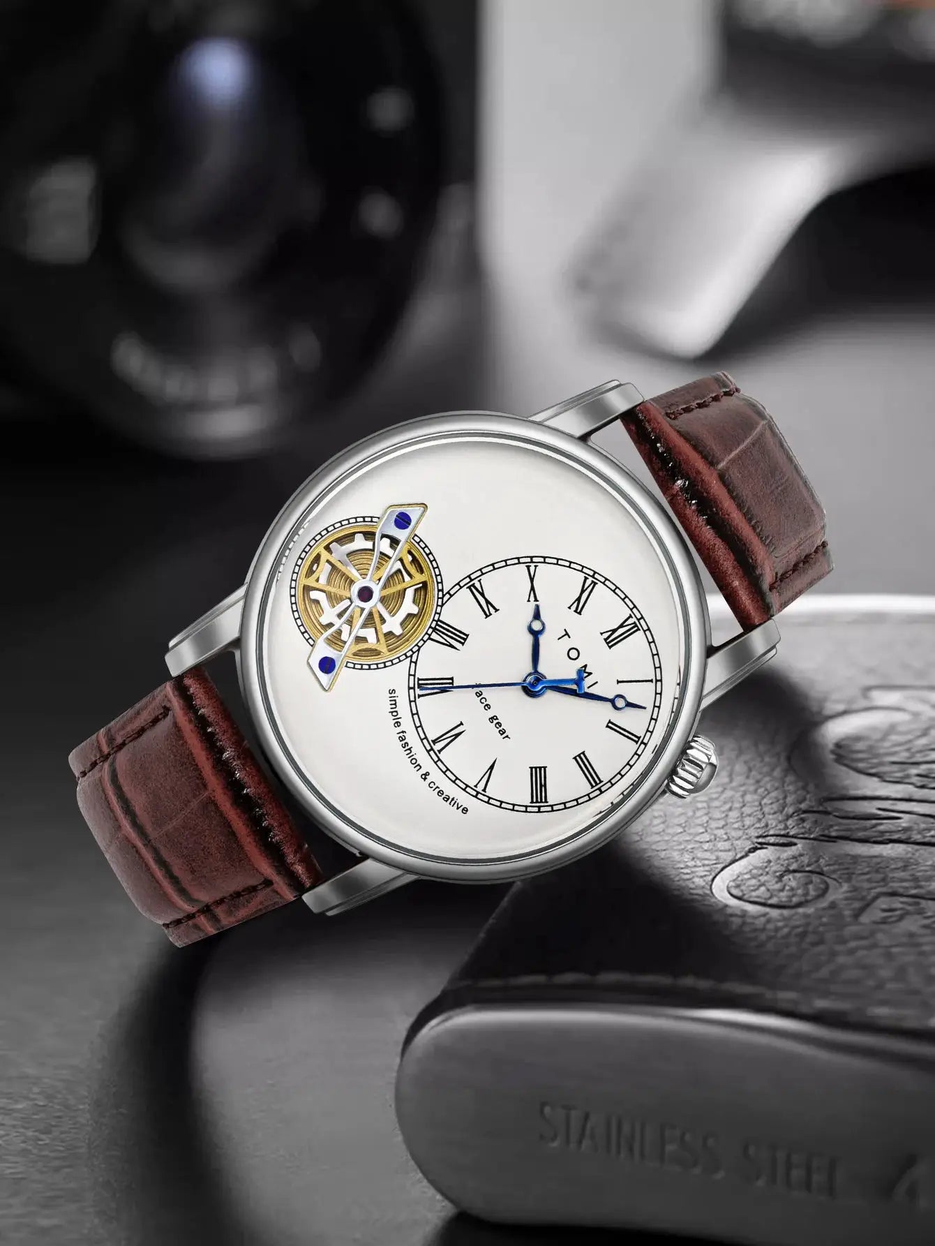 TOMI watch by Simples Market; silver case, white dial with Roman numerals, brown leather strap.