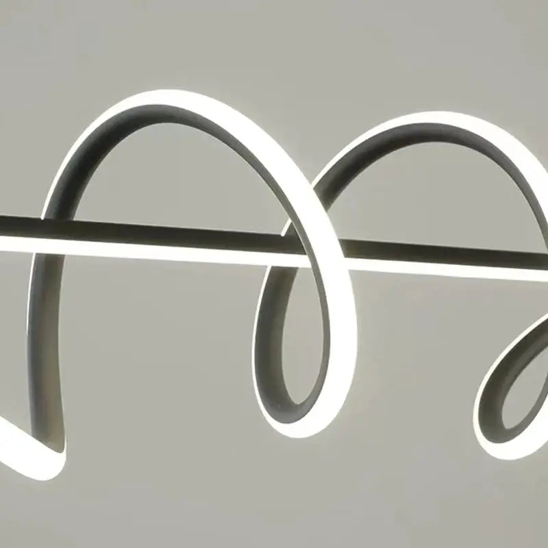 Modern LED pendant light by Simples Market with looping dark metal rings and illuminated edges