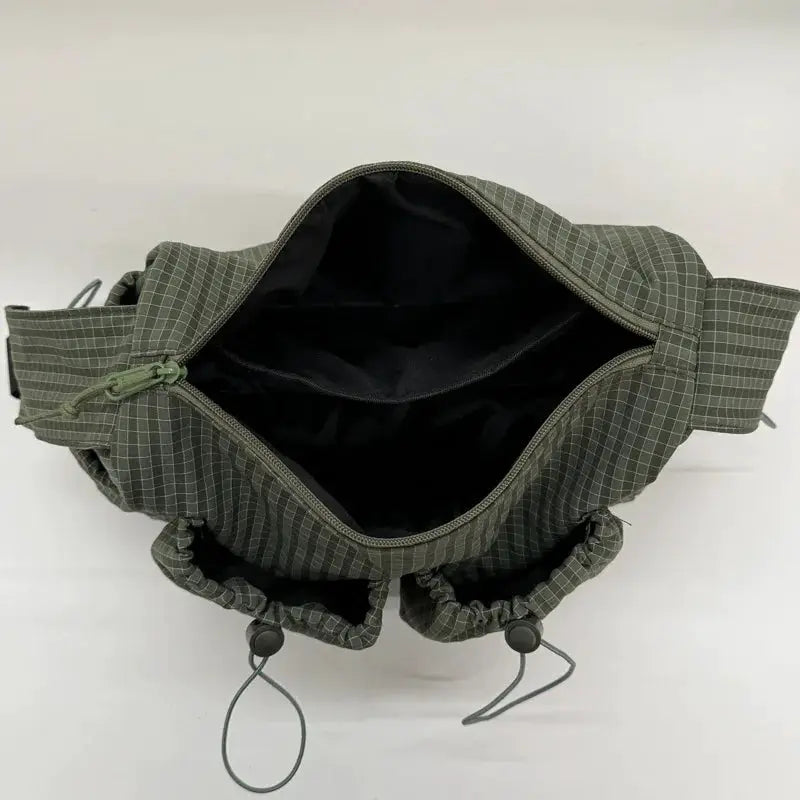 Nylon plaid shoulder bag with zipper top and drawstring closures in olive gray, a compact commuter crossbody.