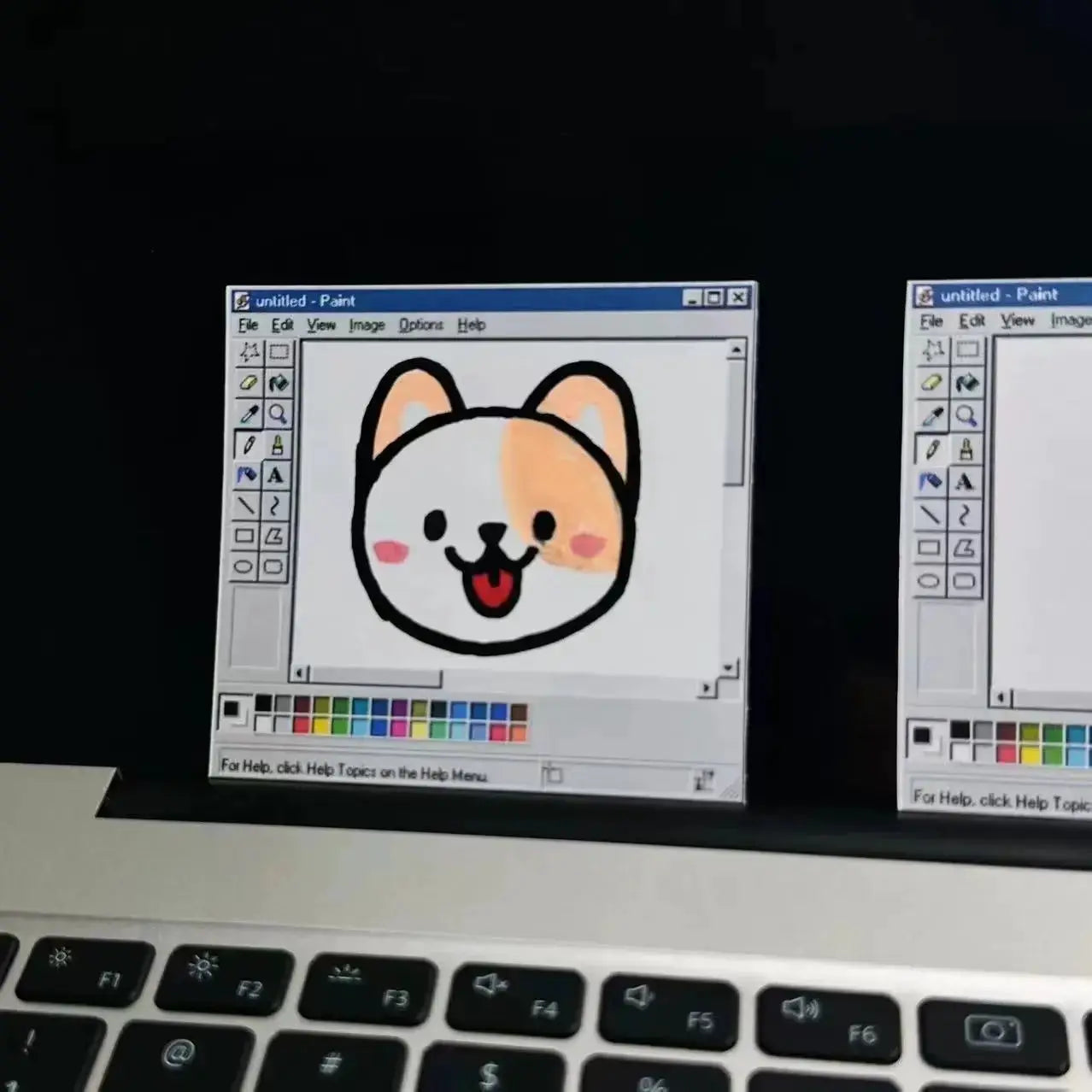 Notepad with retro computer drawing tools pattern, minimalist color scheme; cartoon dog graphic in Windows Paint window