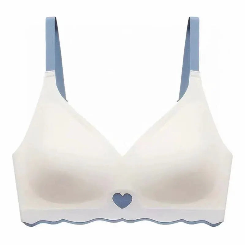 Seamless bralette with white cups, blue adjustable straps, blue heart center, and scalloped blue hem.